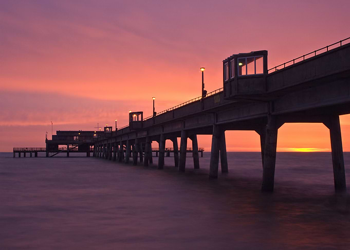 An early morning sunrise captured behind the structure ...