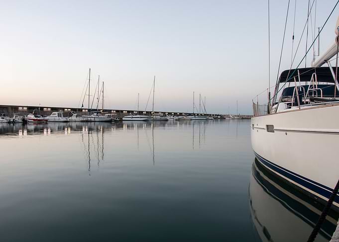 Reflections of a boat in the waters of Puerto Marina