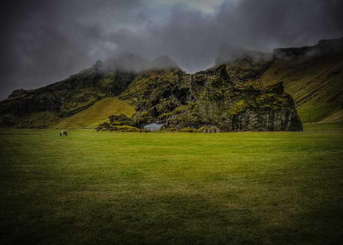 A field near Skógafoss. The buildings are actually bui ...