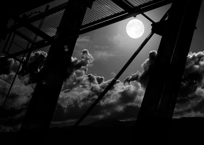 structures of industry against the full moon sky