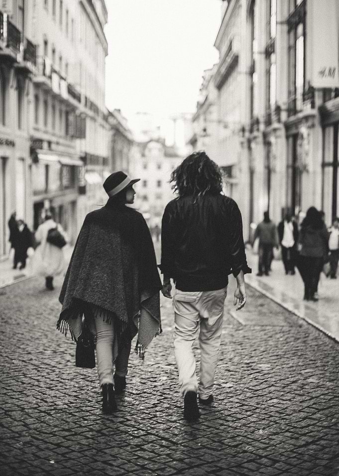A couple in love walking through the streets of Lisbon, ...