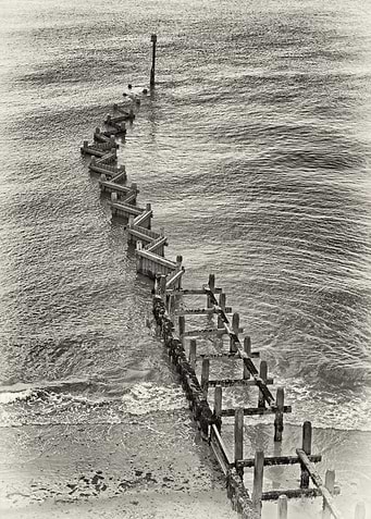 Black and white groins on the Suffolk coast.