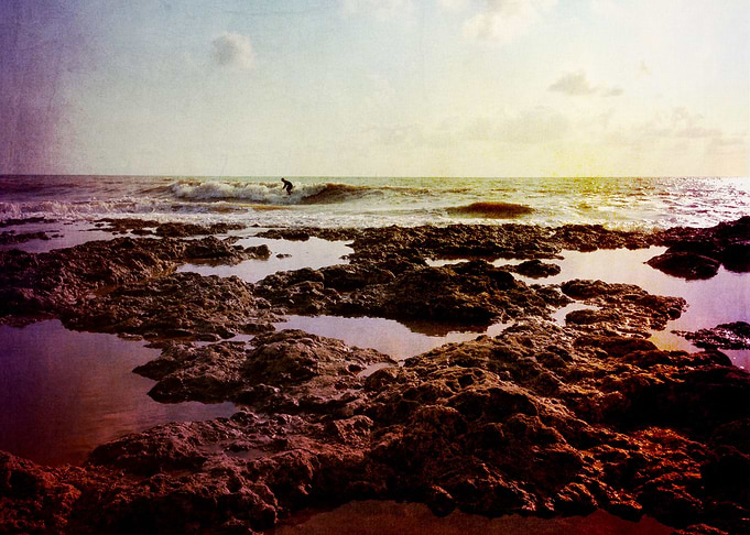 surfer in the rocks