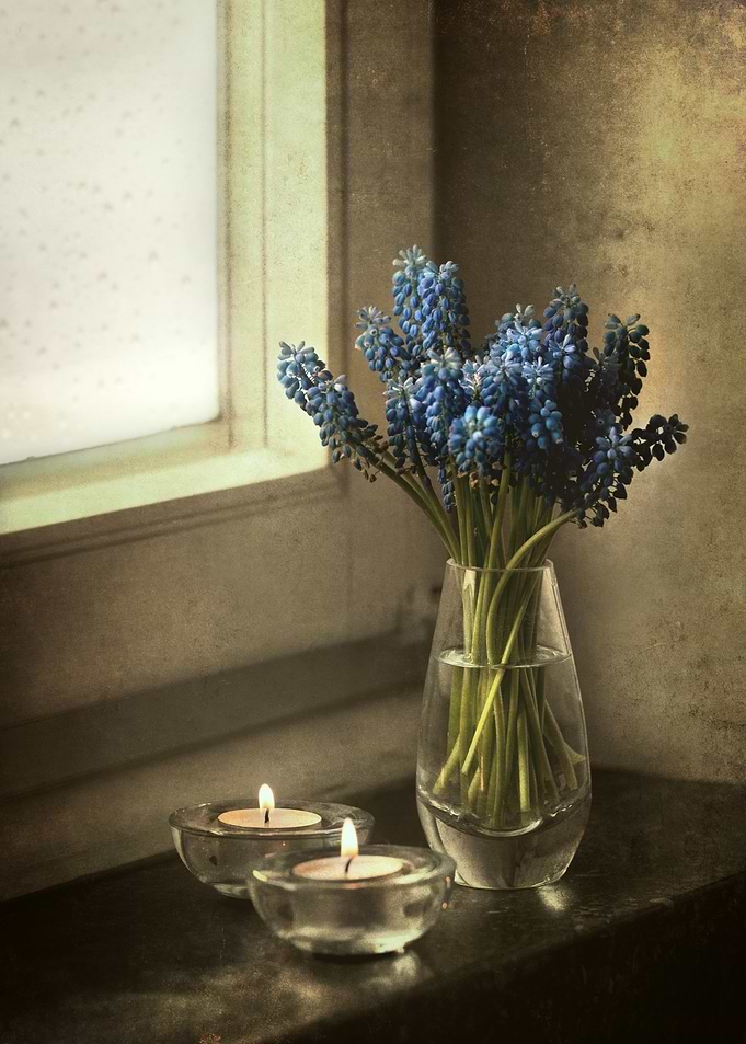 Still life with fresh flowers and two tealights
