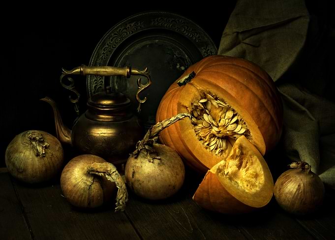 Still life with copper teapot and fresh pumpkins