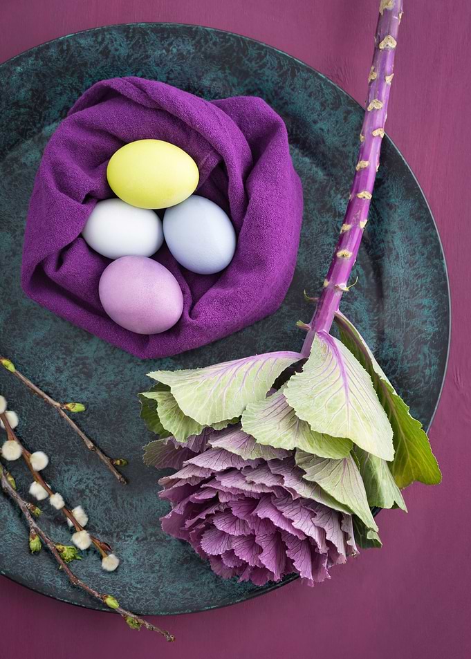 Easter eggs, ornamental cabbage and willow catkins on a ...