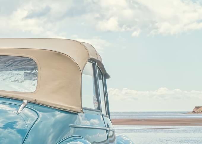 An old classic vintage car at the beach on Prince Edwar ...