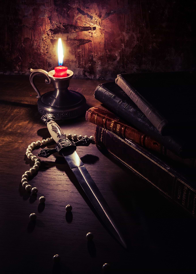 Still life with broken pearl neckace, dagger and pile o ...