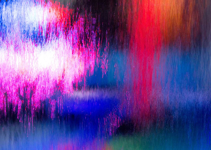 Flow of water on glas with different lights in the bagg ...