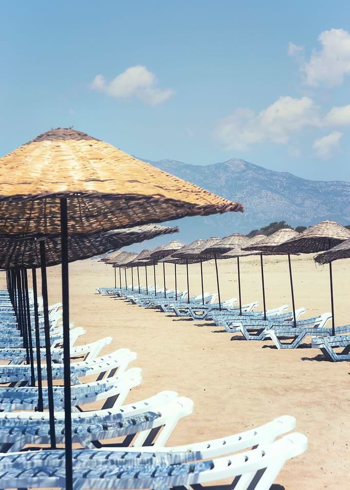 empty beach loungers on a sandy beach