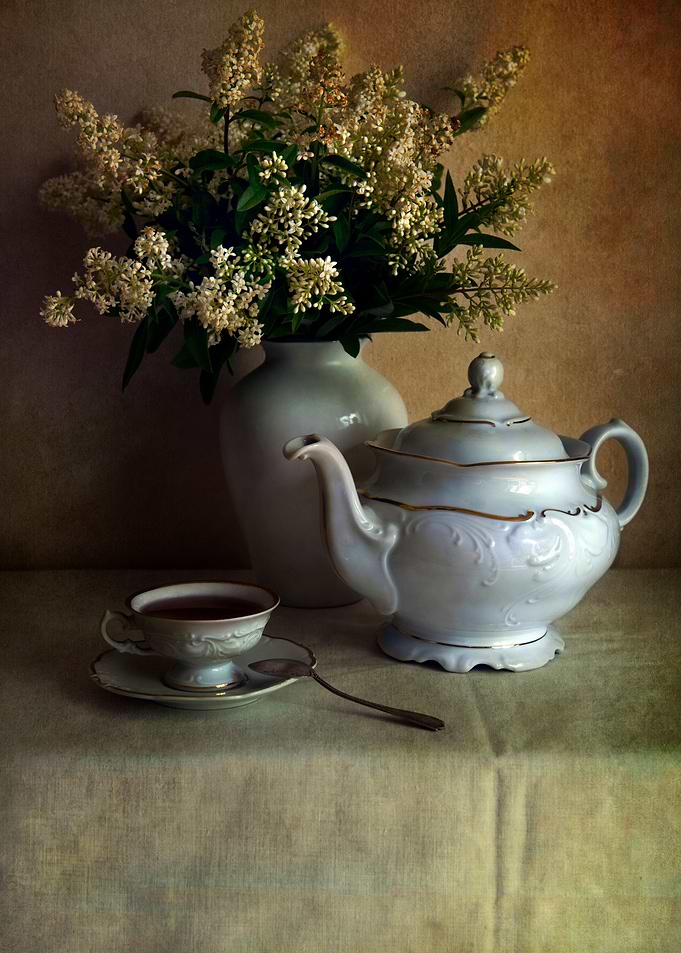 Still life with white teapot and fresh flowers