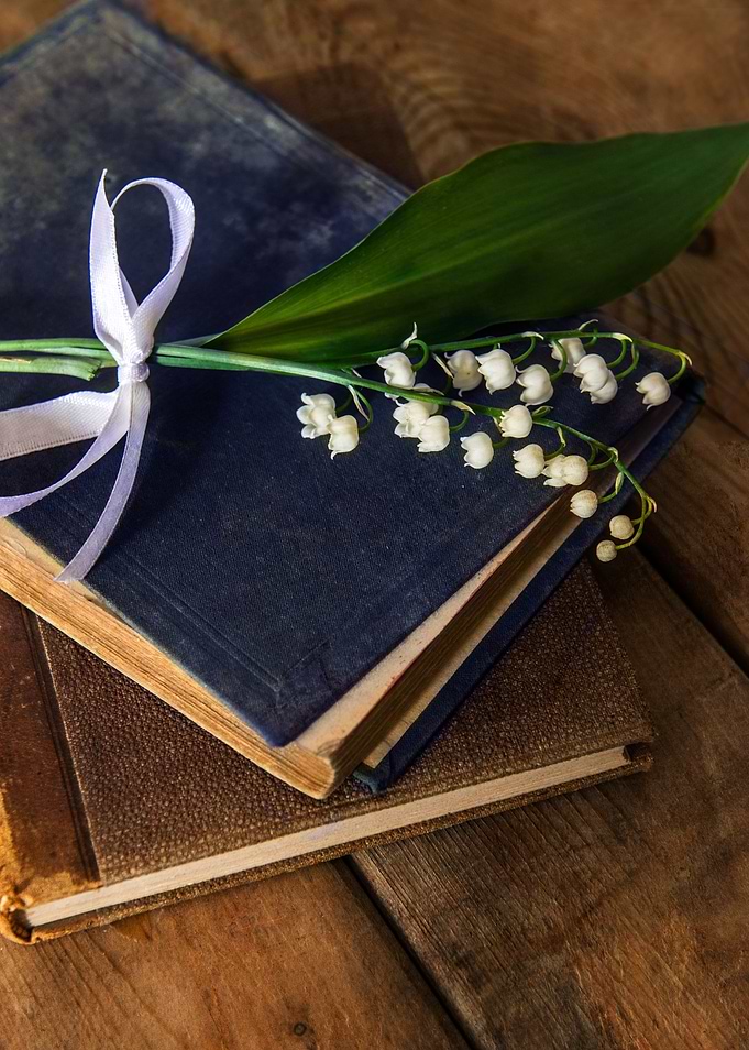 Still life with old books and fresh flowers