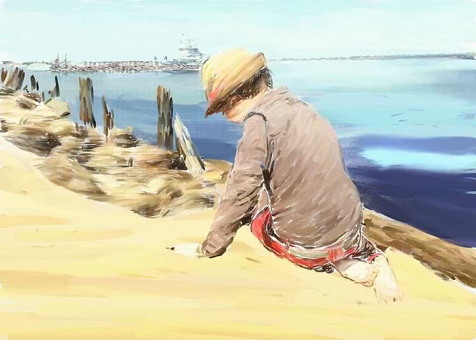 A little boy playing on the beach on a sunny summer day ...