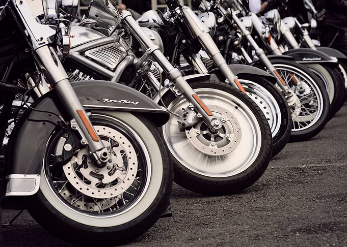 a row of motorcycle's front tyres