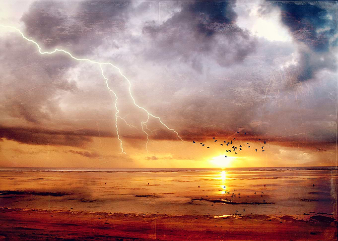 View of tidal flats at sunrise after a tropical thund ...