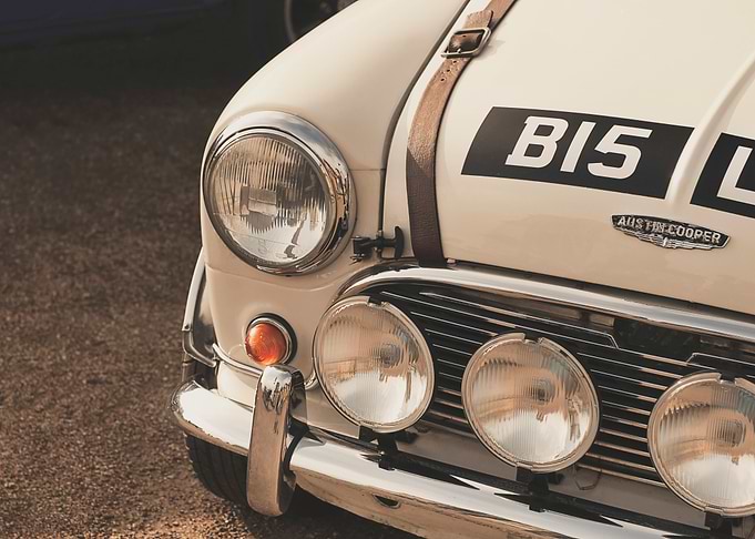 Close up of a front headlight and grill of a classic au ...