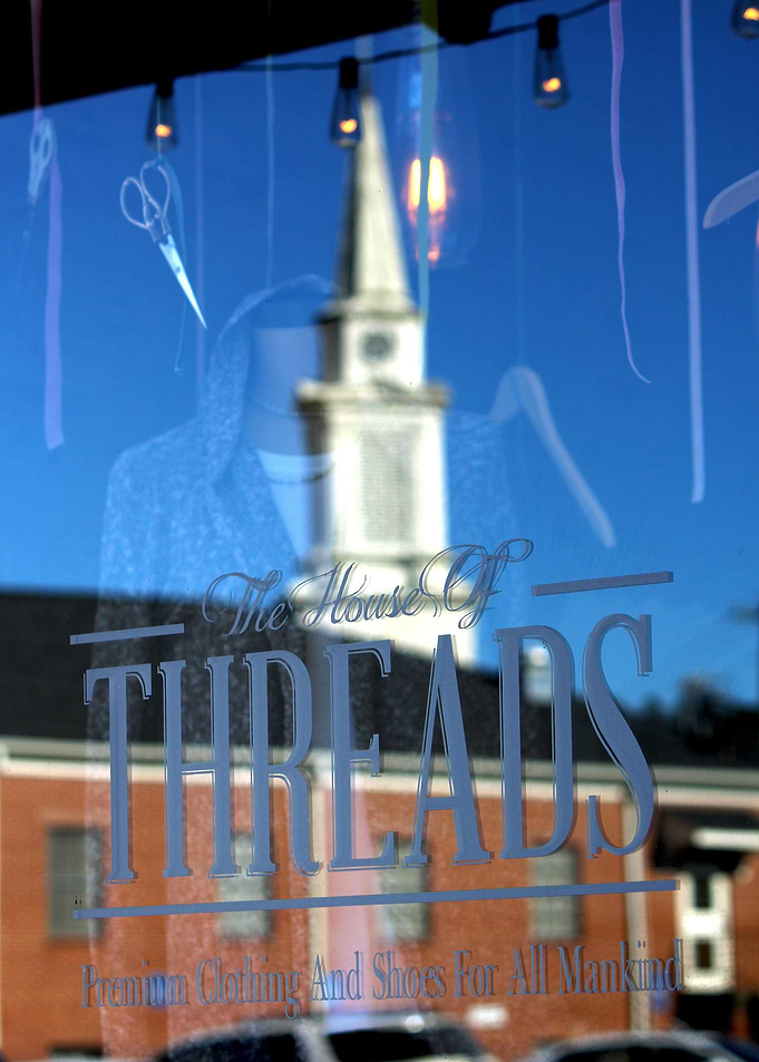 Photo of a reflection of a church in the window of a bu ...