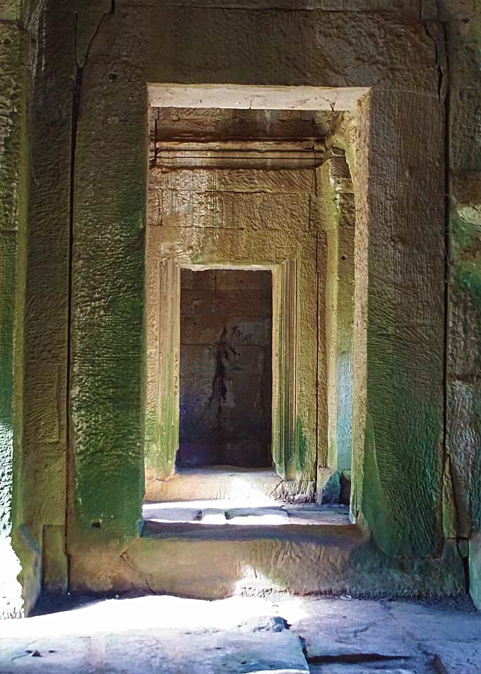 Sunlight streaming into one of the stone doorway passag ...