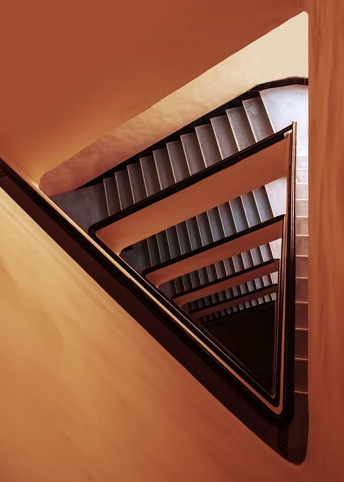 Triangle staircase in red and orange tones. View from t ...