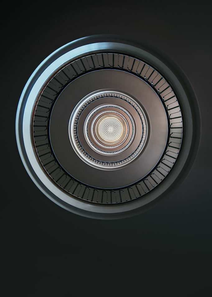 Round staircase with nice ceiling. View from the bottom ...