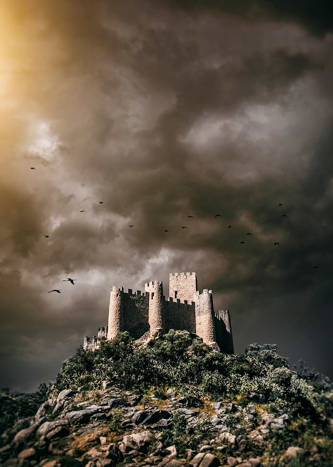 Majestic medieval castle sitting in the top of a rocky ...