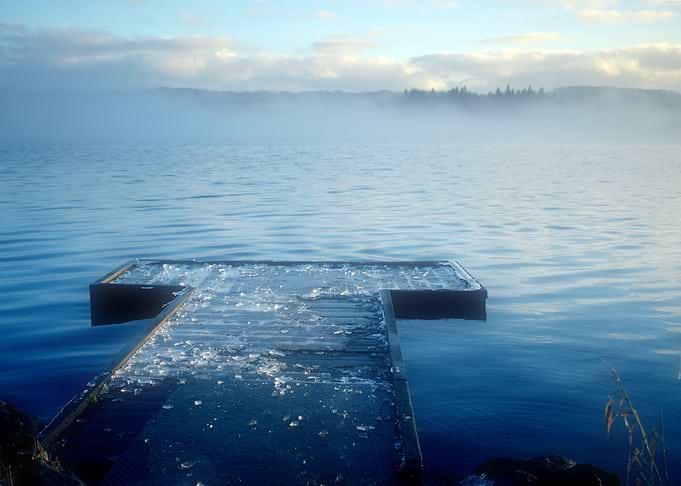 Low fog hangs over the loch as the opposite shore stays ...