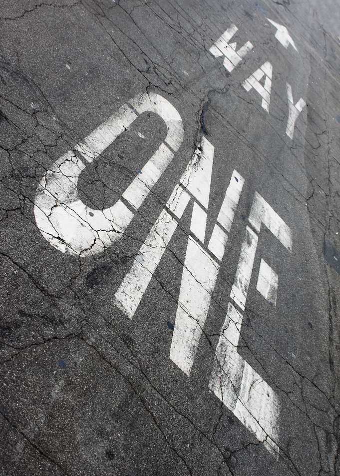 One Way One way sign painted on the street ground.