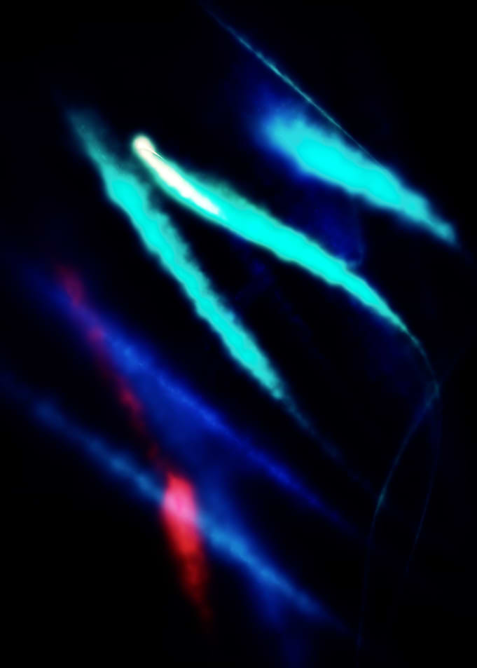 Vapour trails in blue and red dance from left to right