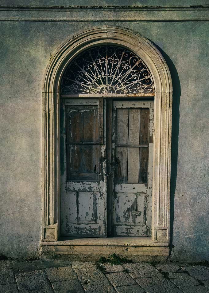 An old doors with ornamented arch