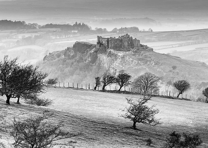 Carreg Cennen castle sits high on a hill near the River ...