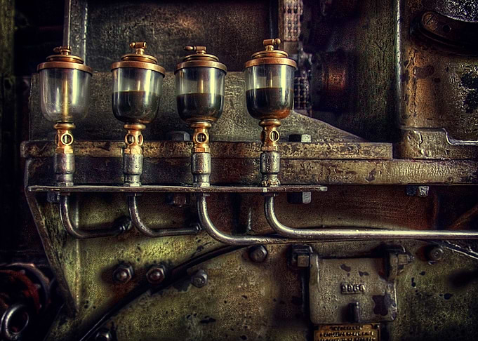 Industrial detail of an old heavy iron machine with oil ...