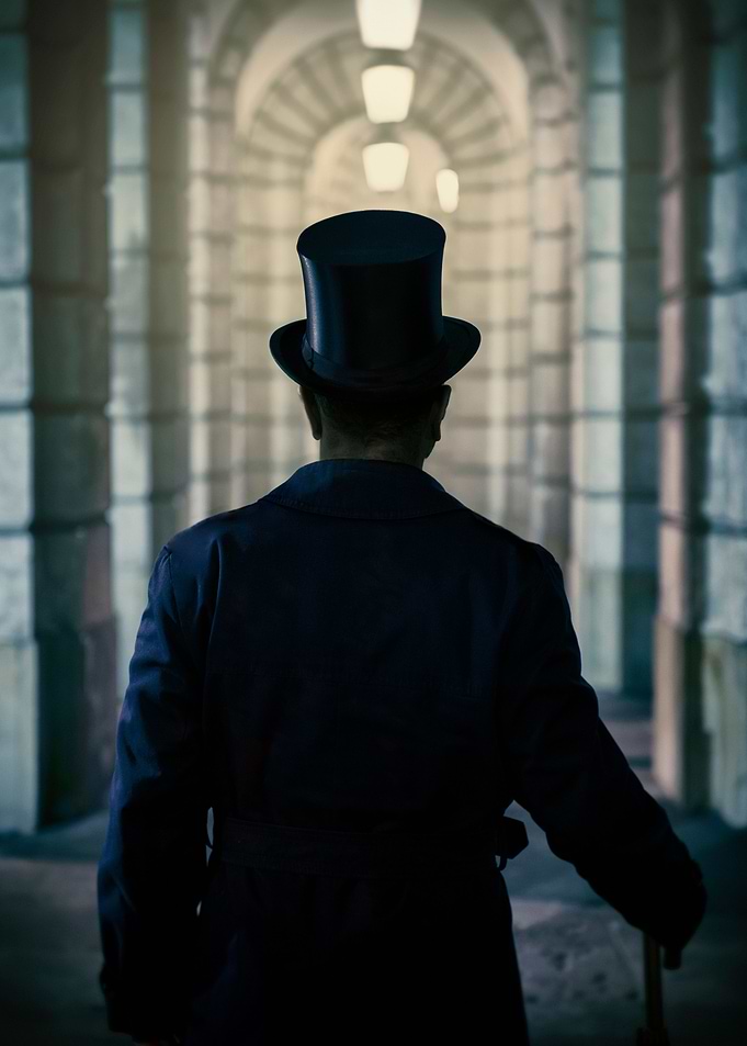 Victorian man wearing top hat in the tunnel with arches ...