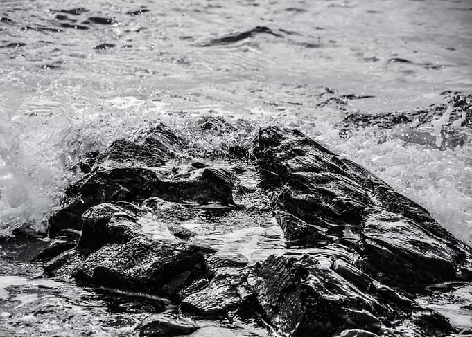 A rock pool at the edge of the Mediterranean Sea on a s ...