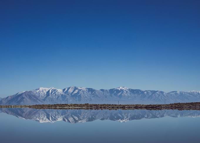 The Wasatch Mountains reflected in the still waters of ...