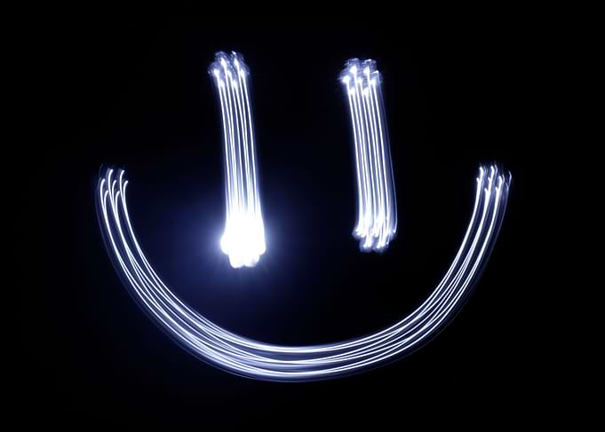 Photograph of a happy face drawing made with long expos ...