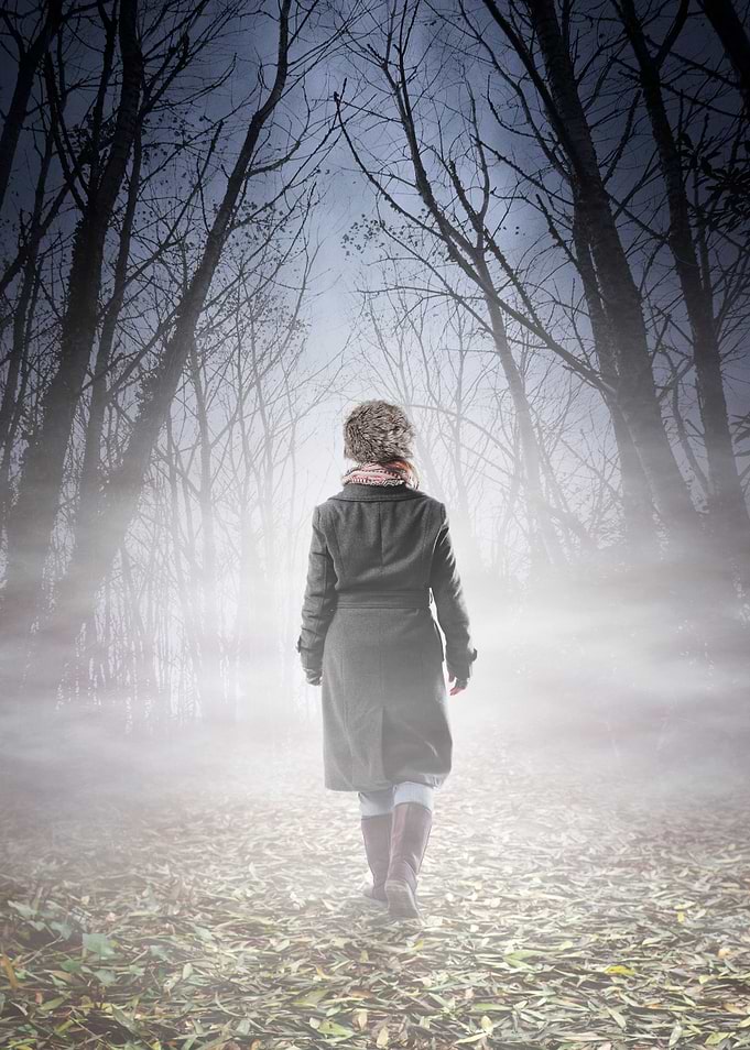 Woman with long coat and fur hat walking into spooky mi ...