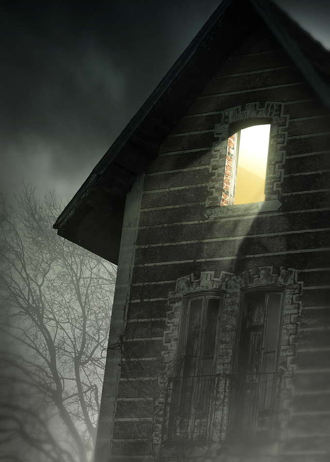 Haunted house with lit window in a dark and mysterious ...