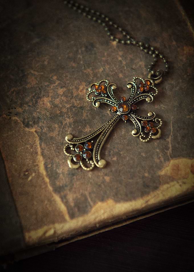 Detailed metal cross and vintage book