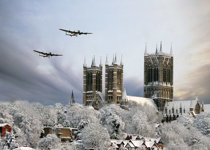 Lancaser Bombera pass over a snow covered Lincoln Cathe ...