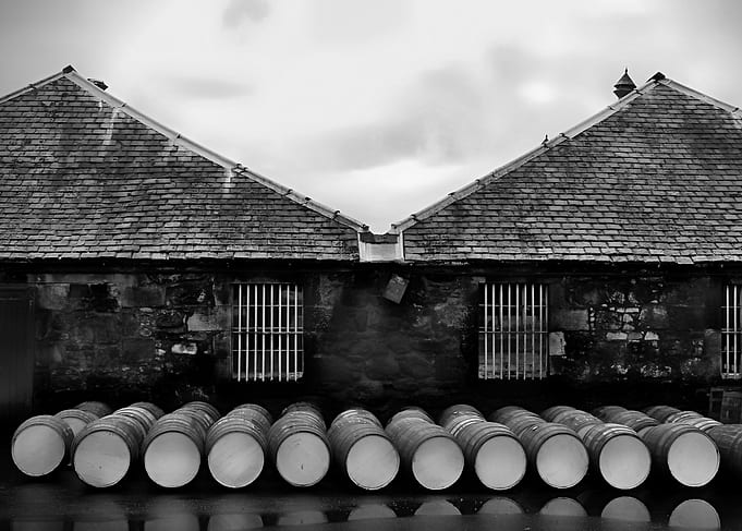 Old used whiskey barrels at the Balblair Distillery in ...