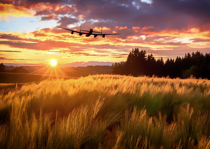 Lone Avro Lancaster Bomber heading in to the setting su ...