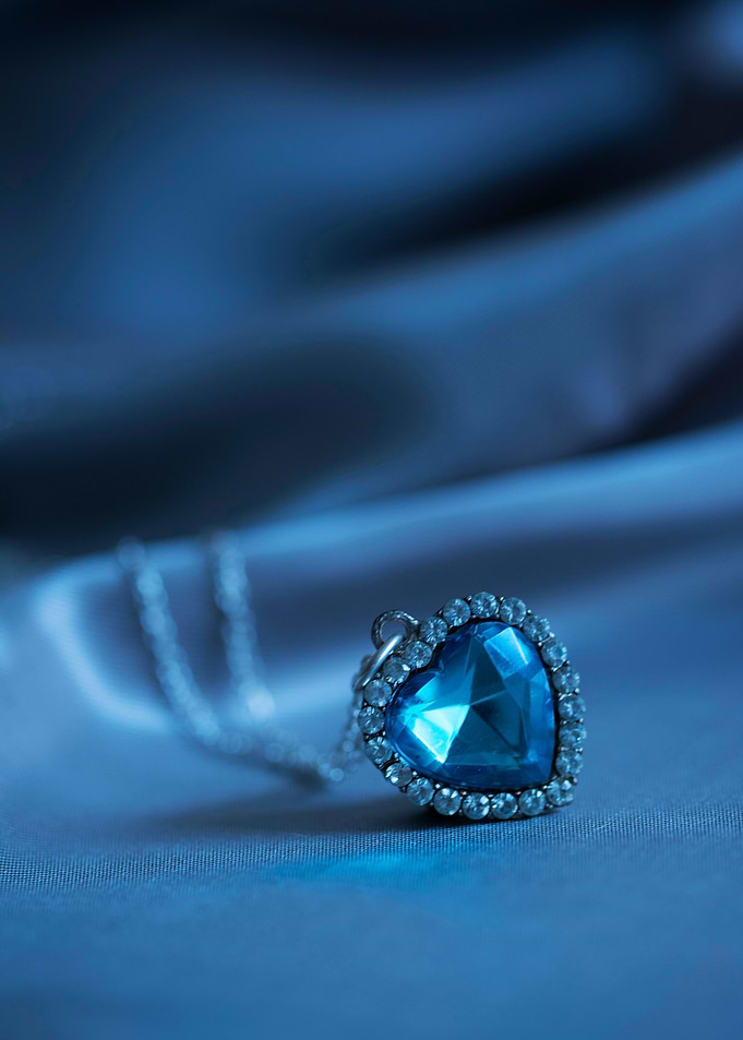 Small heart shaped pendant with blue gem
