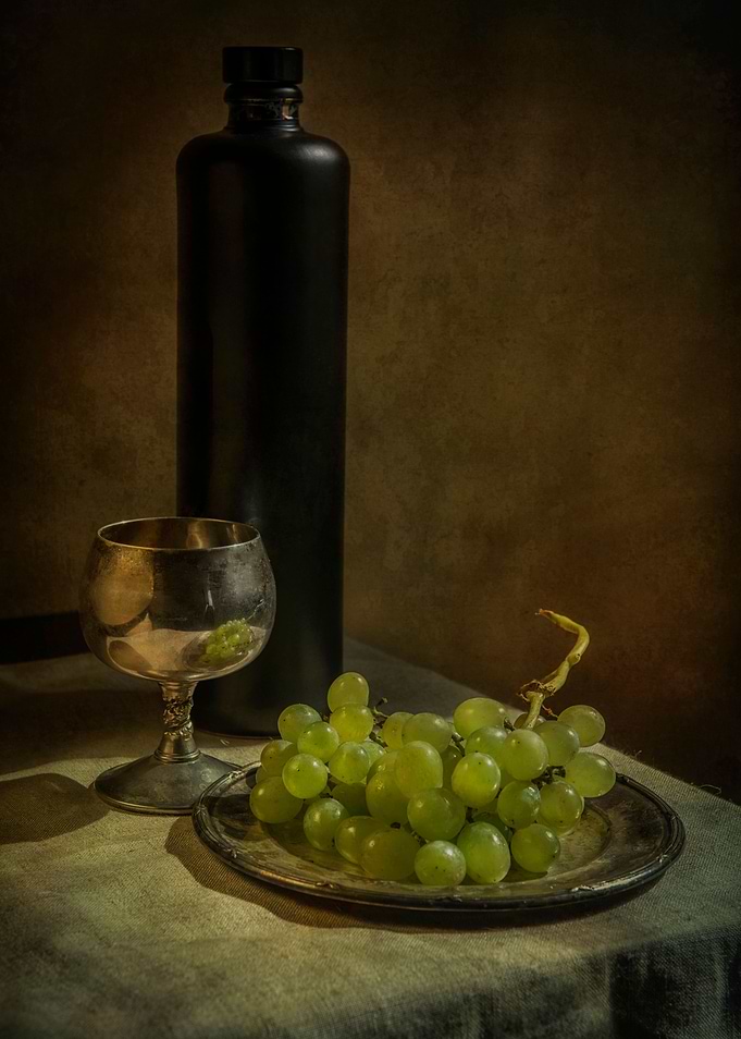 Still life with wine and green grapes