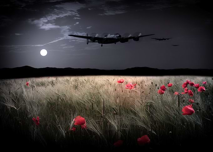 A trio of Royal Air Force Avro Lancaster Bombers lit by ...