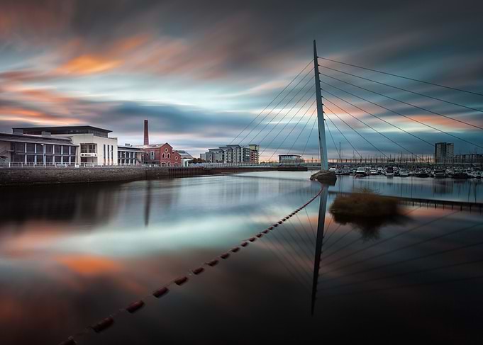 Sunrise and sweeping clouds at the River Tawe and the M ...