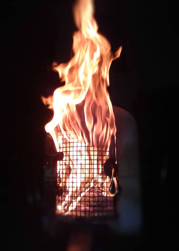 A Homemade wood burner not far after lighting at night, ...