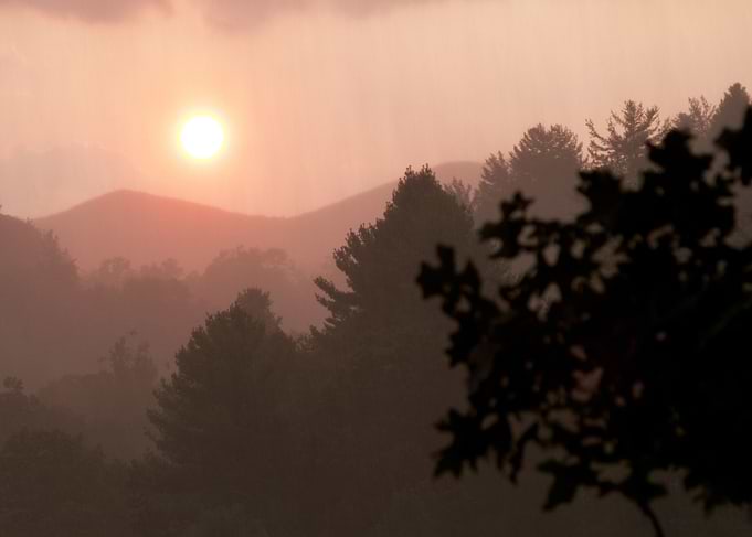 Rainstorm moving in the distance as the sun sets in the ...