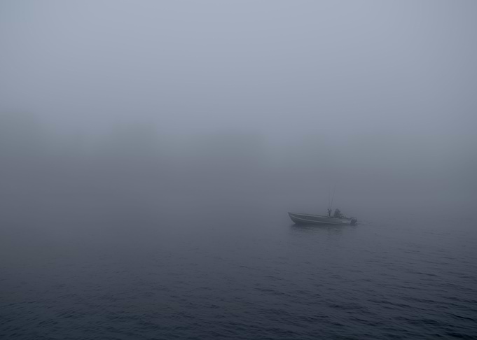 A morning fisherman traveling the channel into Lake Mic ...