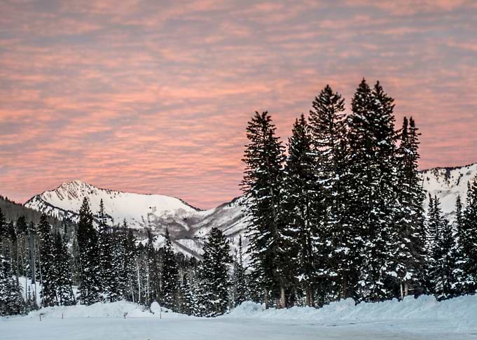 The sun lights the clouds and the snow on the Wasatch M ...
