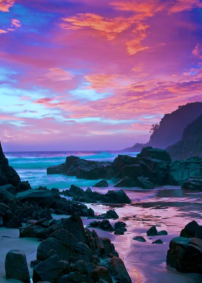 Photo enhanced rugged Oregon coast sunset in magenta, b ...